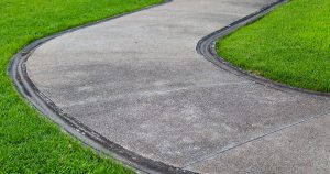 Residential pervious concrete driveway showing typical surface texture and edge deterioration issues