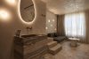 Terrazzo Granitech Medium resin microtopping on hotel bathroom and room walls, floor, and ceiling.