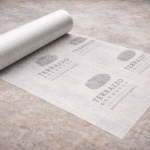 Terrazzo GraniTech fiberglass reinforcing mesh roll partly unrolled on a microtopping floor